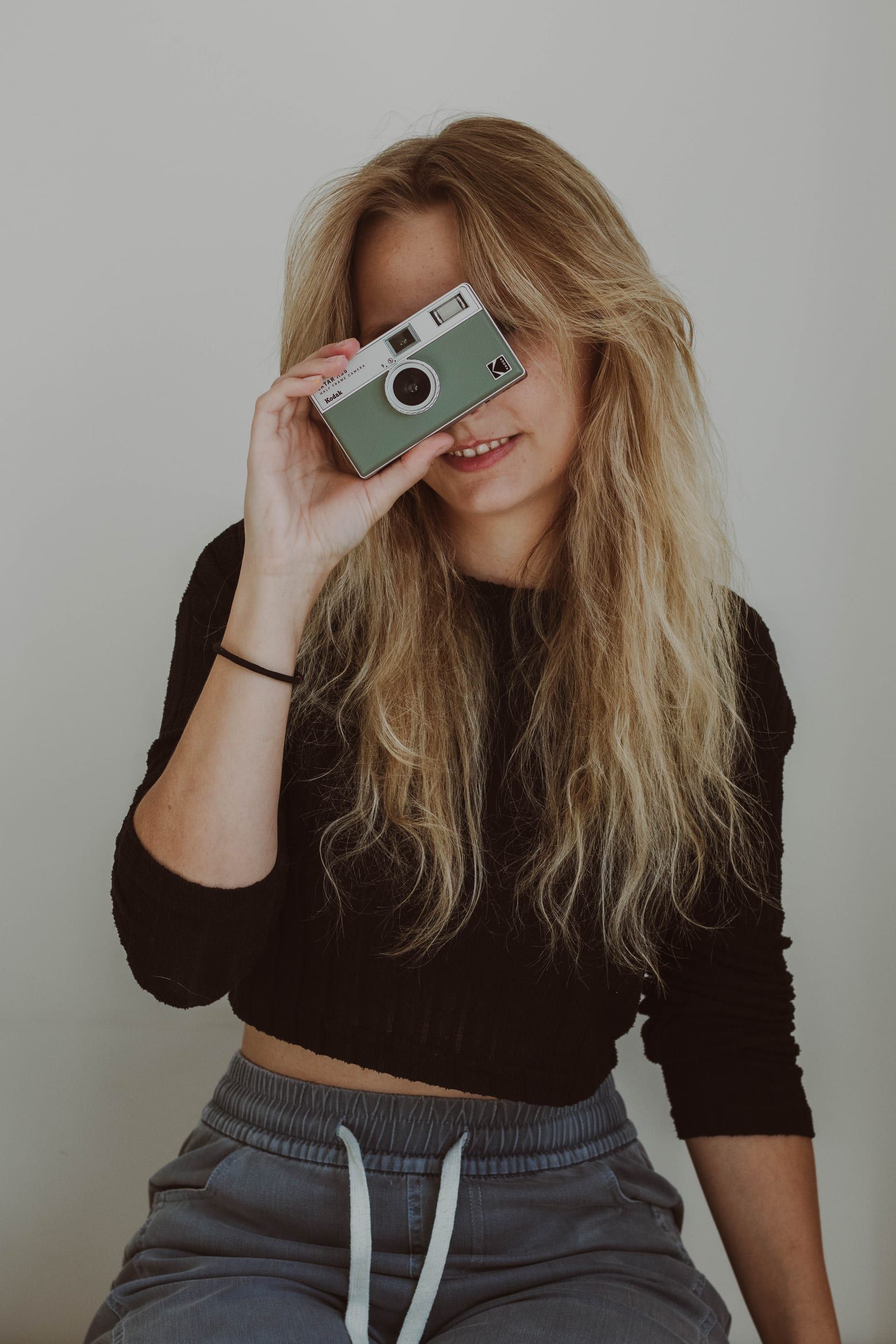 Woman holding a compact camera up to her eye